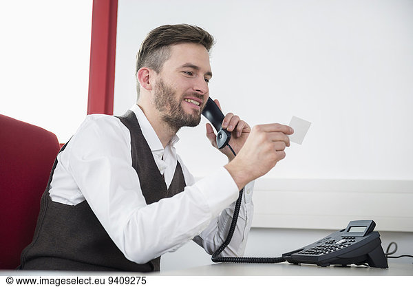Man telephone conversation business card