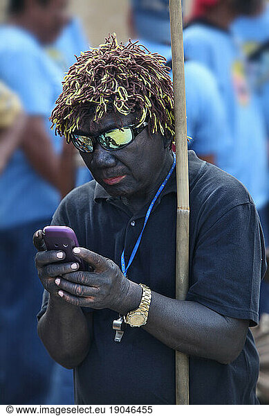 Man texting during Ati Atihan festival  Ibajay.