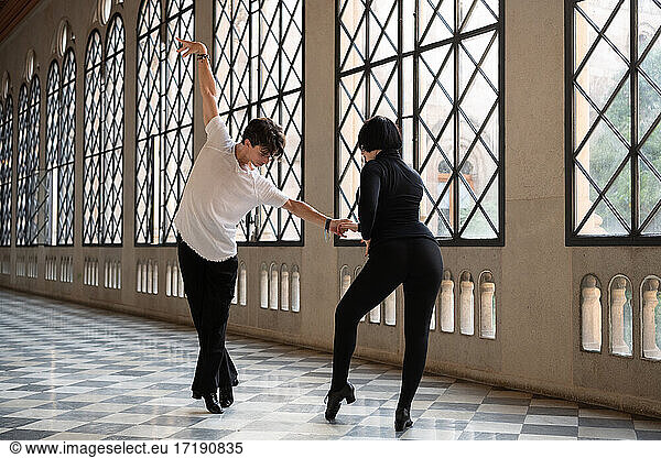 Man tiptoeing near dance partner