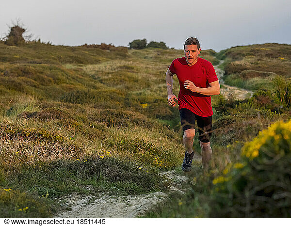 Man trail running no cliff of Getxo