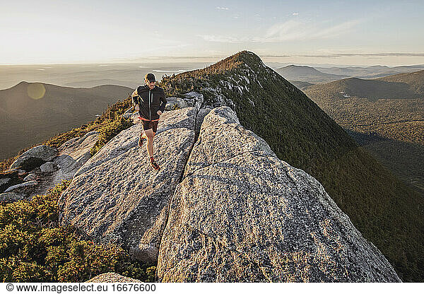 Man trail runs along summit ridge of mountain with amazing views