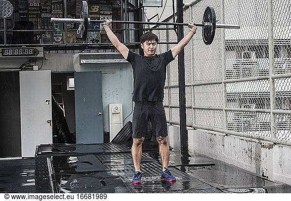 man training at rooftop gym in Bangkok