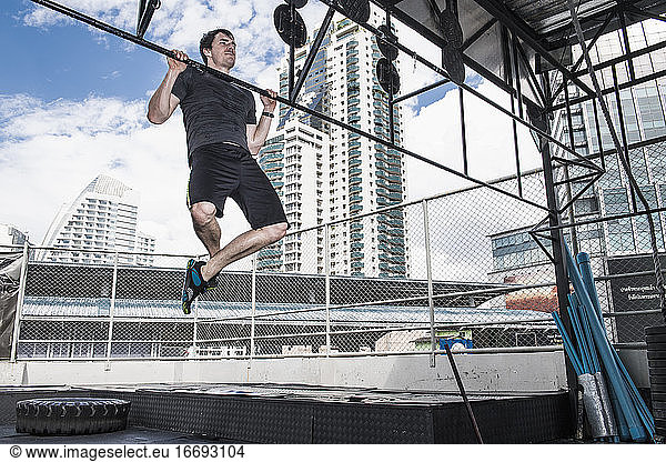 man training at rooftop gym in Bangkok