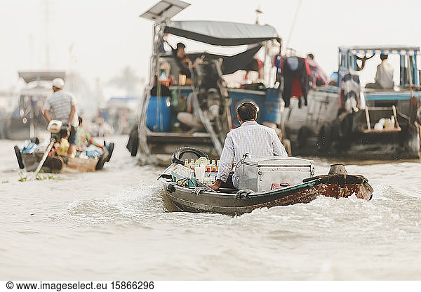 Man transporting food in boat  Cai Rang Floating Market; Can Tho  Vietnam
