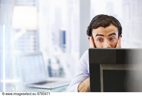 Man using computer in office stressed and worried