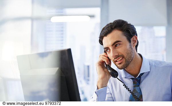 Man using landline phone in office