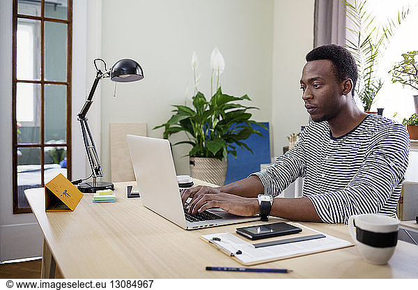 Man using laptop at home office