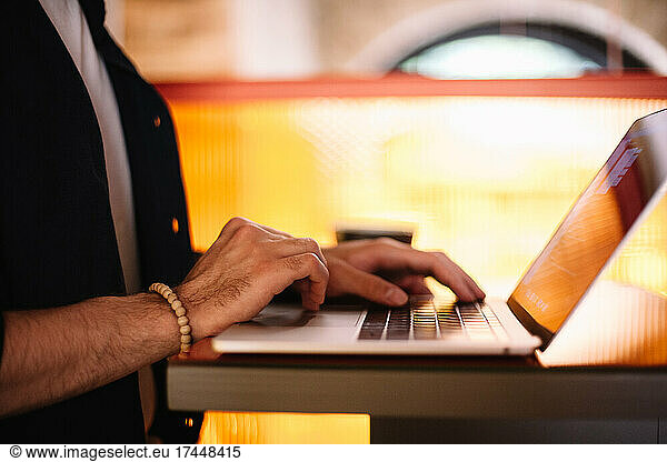 Man using laptop computer at cafe