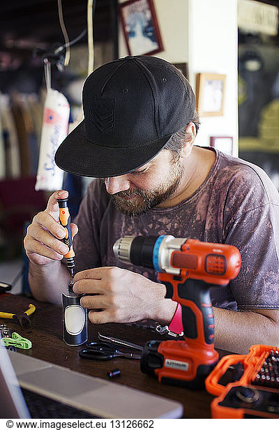 Man using screwdriver in workshop