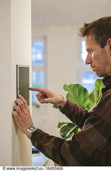 Man using smart home device at home