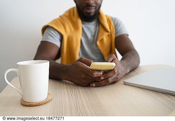 Man using smart phone at home