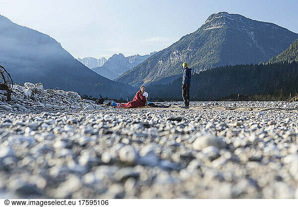 Man waking up by friend at Karwendel Mountains on vacation  Bavaria  Germany