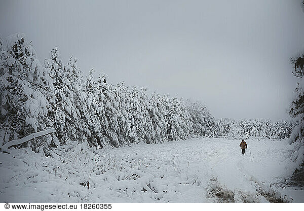 Man walking across wintery field in Wisconsin