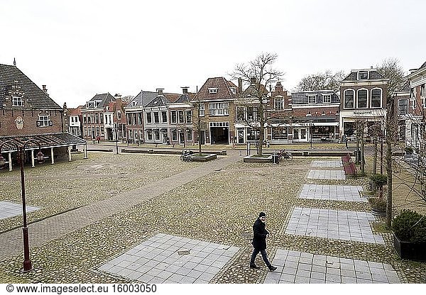 Man walking in city centre of Workum  Friesland  Netherlands.
