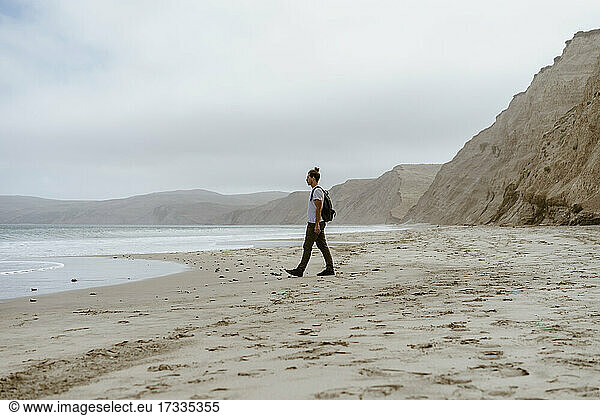 Man walking near sea on beach at Point Reyes in California  USA