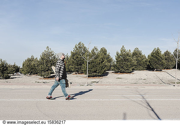 Man walking with his longboard