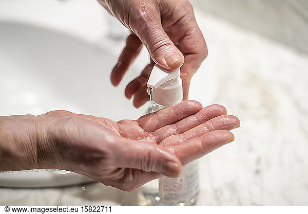 Man washing hands  using sanitizer  close up