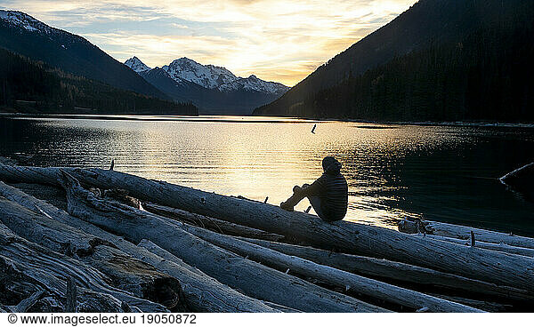 Man watching sunset atÃ?Â DuffeyÃ?Â Lake  Duffey Lake Provincial Park  British Columbia  Canada