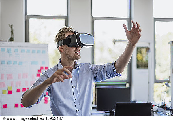 Man wearing VR glasses in office