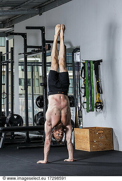 man with beard performing handstand at gym in Bangkok