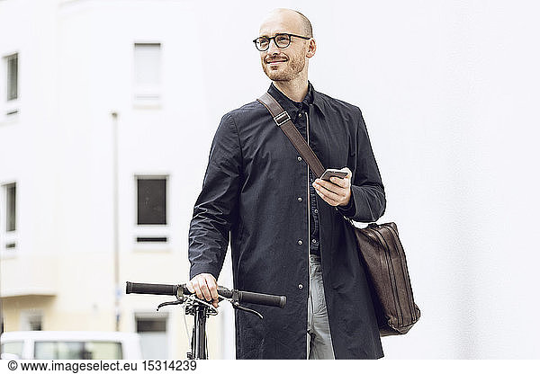 Man with bicycle going to work holding his smartphone