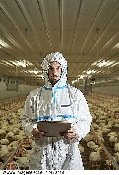 Man with clipboard in chicken factory