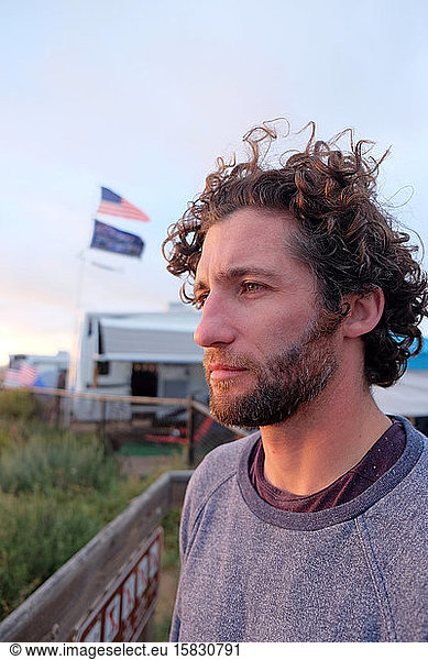 Man with Curly Hair in Profile Looking Out Pensively at Ocean