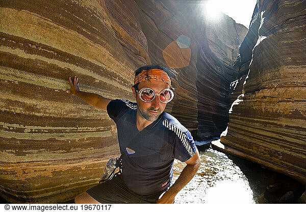 man with funny glasses and bandana hiking in desert canyon  Deer Creek  Grand Canyon  Arizona