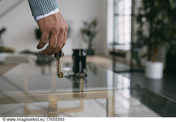 Man with house keys at home