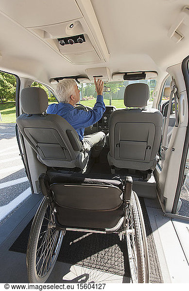 Man with muscular dystrophy and diabetes adjusting an accessible van for driving