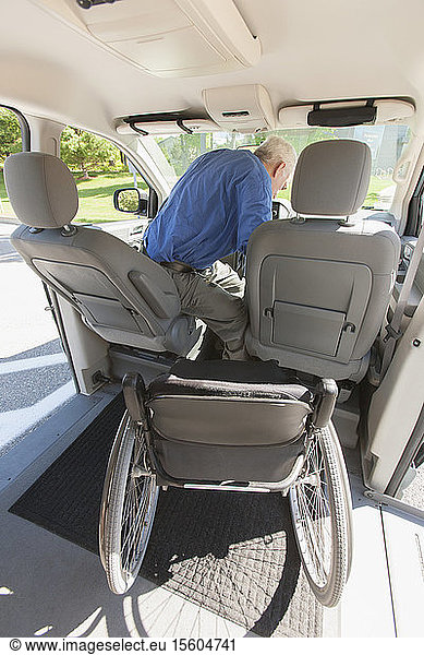 Man with muscular dystrophy and diabetes on the driving seat in an accessible van