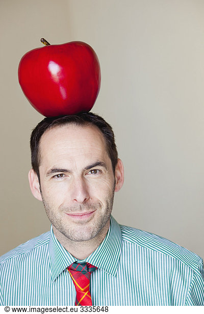 man with oversized apple on his head