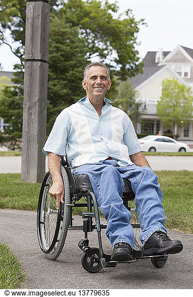 Man with spinal cord injury in a wheelchair enjoying outdoors