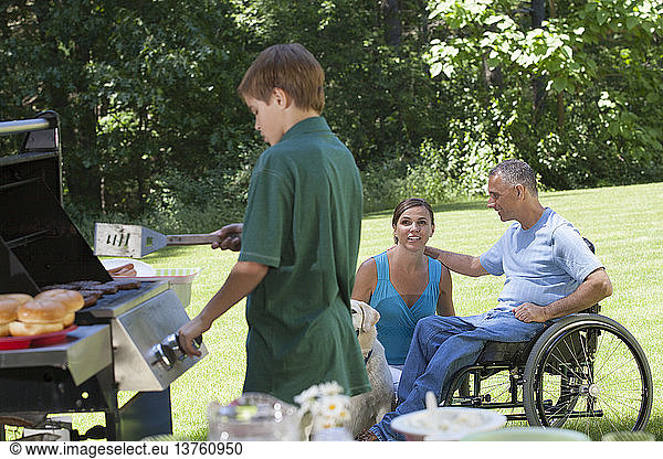 Man with spinal cord injury in wheelchair at family picnic