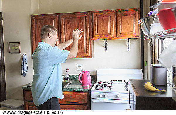 Man with Visual Impairment working in the kitchen at his home