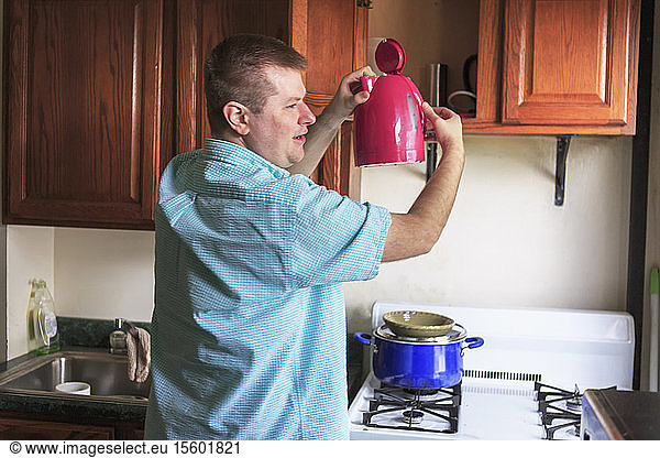Man with Visual Impairment working in the kitchen at his home