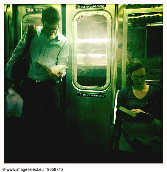 Man & Woman Reading Books on Subway
