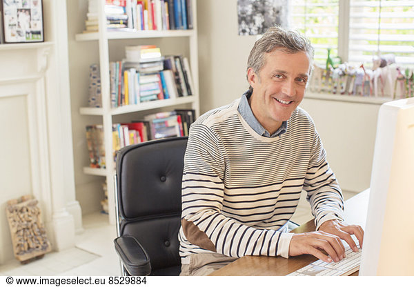Man working at computer in home office