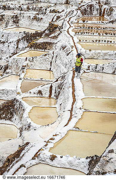Man working at Salineras de Maras  Sacred Valley  Peru