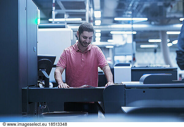 Man working in books printing industry  Bremgarten  Hartheim am Rhein  Baden-Wuerttemberg  Germany