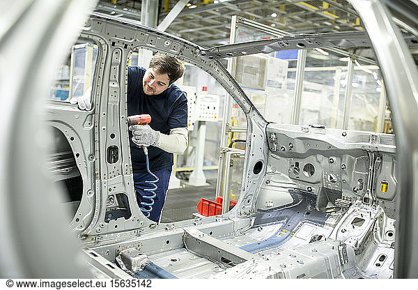 Man working in modern car factory