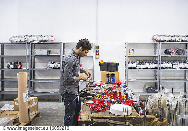 Man working on fencing supplies on workbench