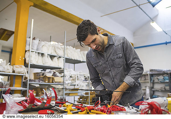 Man working on fencing supplies on workbench