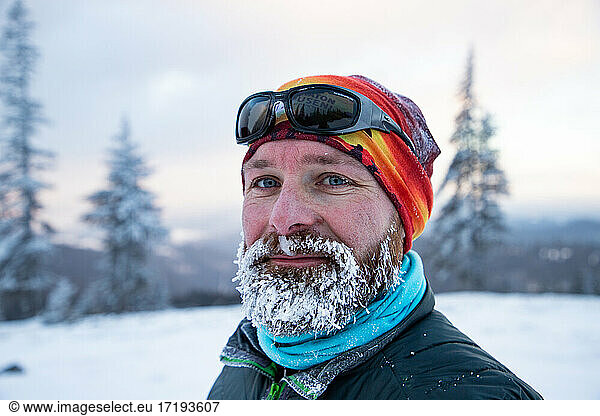 Mann bei extremem Wetter im winterlichen Gebirge