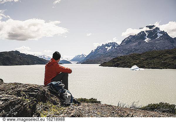 Mann schaut auf einen Fluss während er im Torres Del Paine National Park sitzt Patagonien Chile Südamerika
