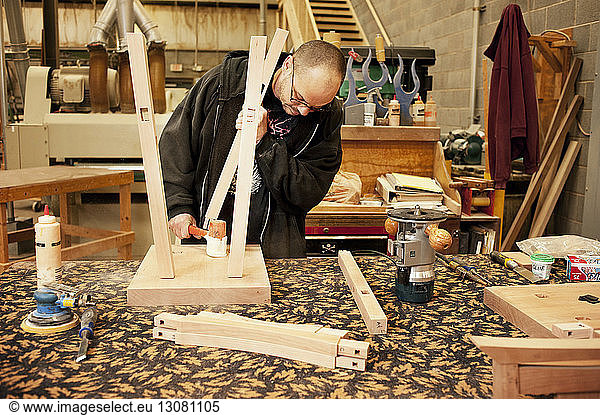 Manual worker making stool at workshop
