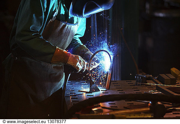 Manual worker welding in workshop