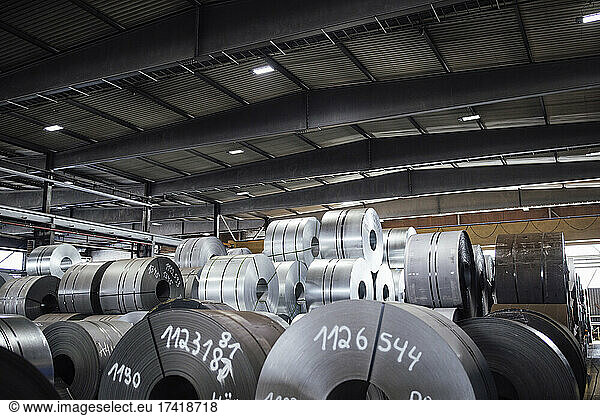 Manufactured metal sheet rolls in warehouse