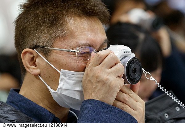 March 3  2018  Yokohama  Japan - A man tries out the new Canon camera EOS Kiss M at the CP+ Camera & Photo Imaging Show 2018 in Pacifico Yokohama. Japan's largest camera and photo imaging exhibition bring together 1 123 exhibitor booths during the four-day trade show at the Pacifico Yokohama and OSANBASHI Hall. Organizers expect approximately 70 000 visitors until March 4th.