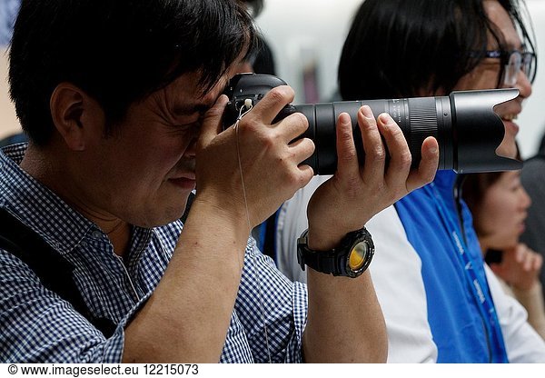 March 3  2018  Yokohama  Japan - A man tries out the new long lens Tamron 100-400mm F/4 Di VC USD (Model A034) at the CP+ Camera & Photo Imaging Show 2018 in Pacifico Yokohama. Japan's largest camera and photo imaging exhibition bring together 1 123 exhibitor booths during the four-day trade show at the Pacifico Yokohama and OSANBASHI Hall. Organizers expect approximately 70 000 visitors until March 4th.